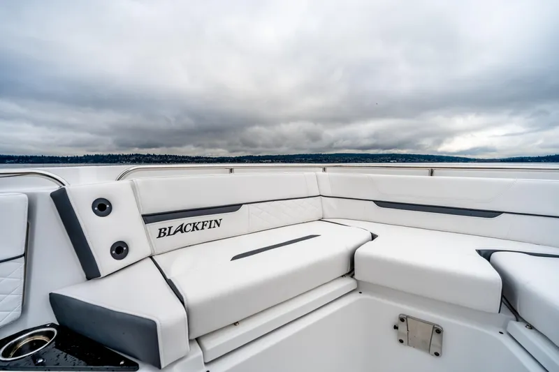 Blackfin 252cc Yacht Photos Pics 2023 Blackfin 252 CC boat interior with white seating and overcast sky.