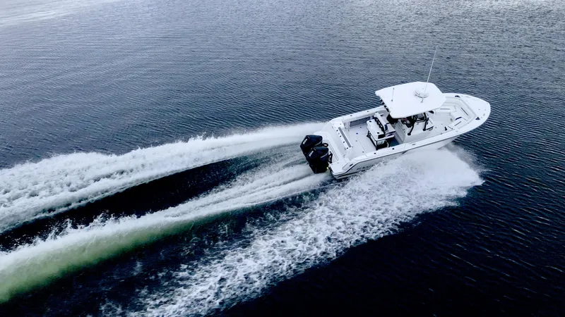 Blackfin 252cc Yacht Photos Pics 2023 Blackfin 252 CC boat cruising on open water, aerial view.