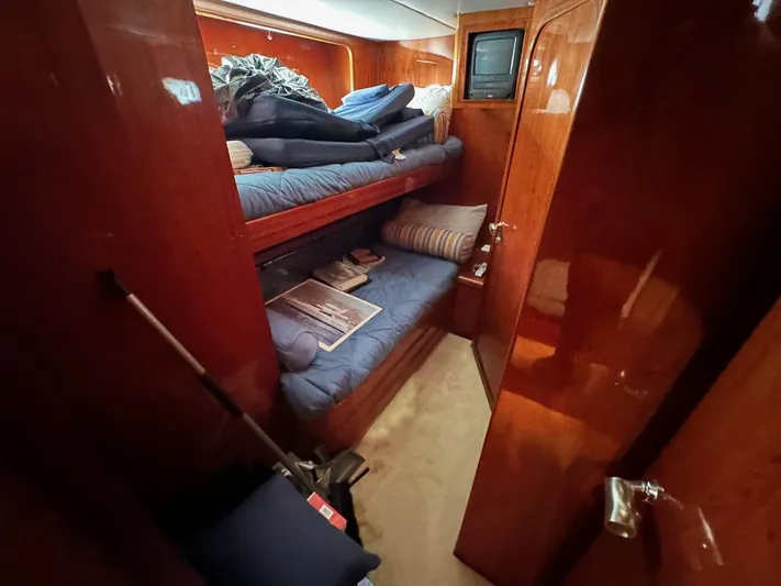 Euphoria Yacht Photos Pics Cozy cabin interior of 2001 Johnson 70 yacht with bunk beds and wooden finish.