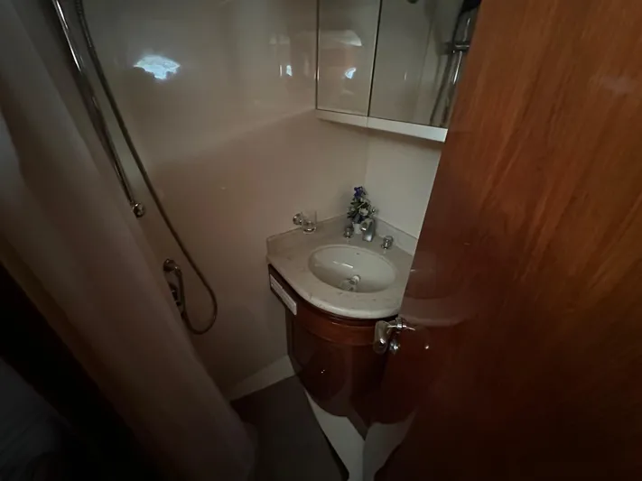 Euphoria Yacht Photos Pics Compact bathroom in a 2001 Johnson 70 yacht with sink and shower.