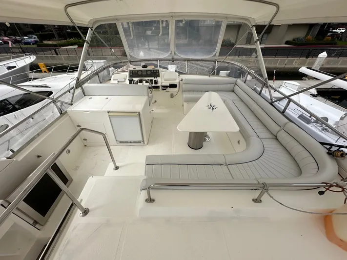 Euphoria Yacht Photos Pics Spacious deck of 2001 Johnson 70 yacht with seating and table.