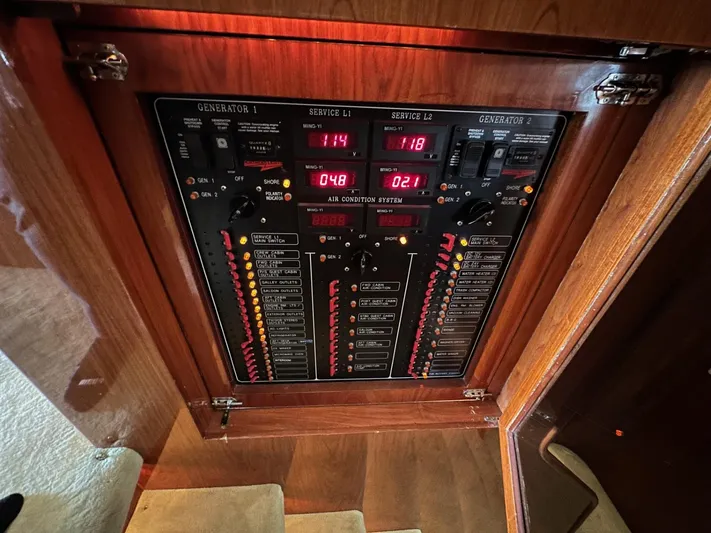 Euphoria Yacht Photos Pics Electrical control panel on a 2001 Johnson 70 yacht, featuring generator and service indicators.