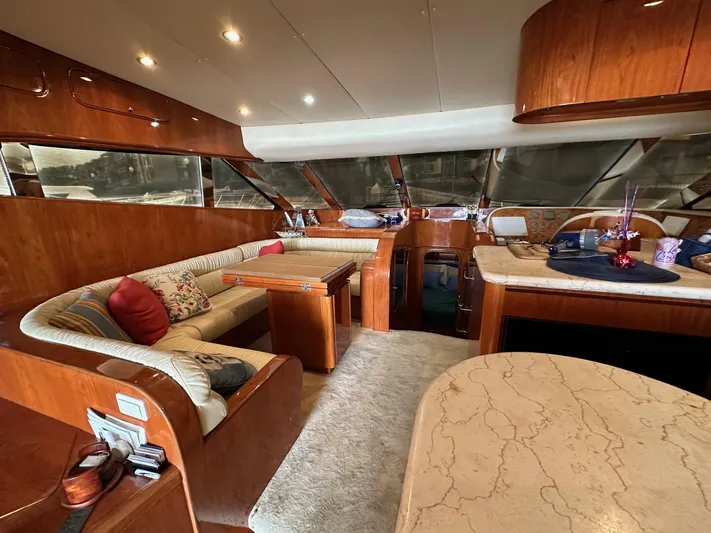 Euphoria Yacht Photos Pics Luxurious interior of a 2001 Johnson 70 yacht with elegant wood finishes and plush seating.