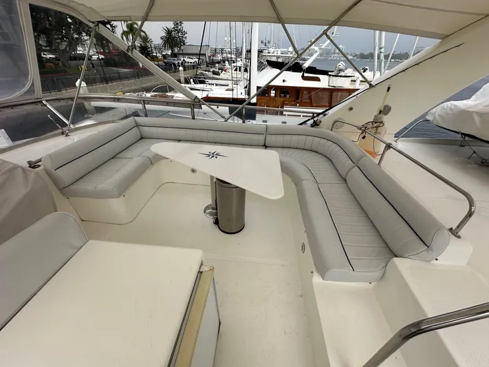 Euphoria Yacht Photos Pics Spacious seating area on 2001 Johnson 70 yacht with marina view.