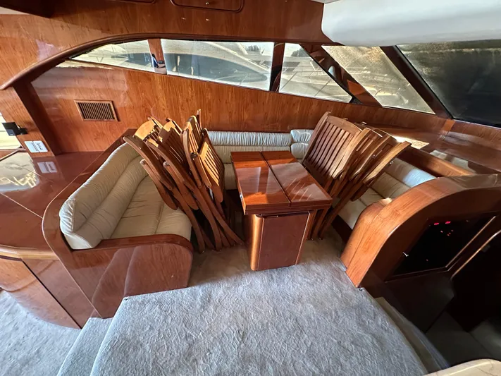 Euphoria Yacht Photos Pics Luxurious wooden interior of a 2001 Johnson 70 yacht with dining area.