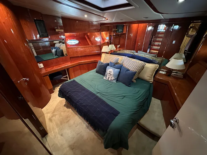 Euphoria Yacht Photos Pics Luxurious 2001 Johnson 70 yacht bedroom with elegant wood paneling and cozy bedding.