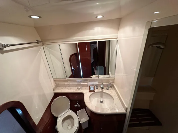 Euphoria Yacht Photos Pics Luxurious yacht bathroom with marble sink, mirror, and toilet in a 2001 Johnson 70 model.