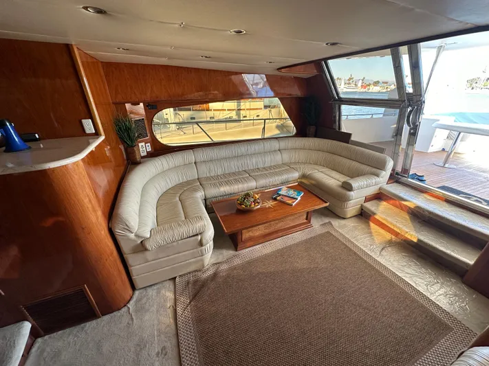 Euphoria Yacht Photos Pics Luxurious interior of 2001 Johnson 70 yacht with plush seating and wooden accents.