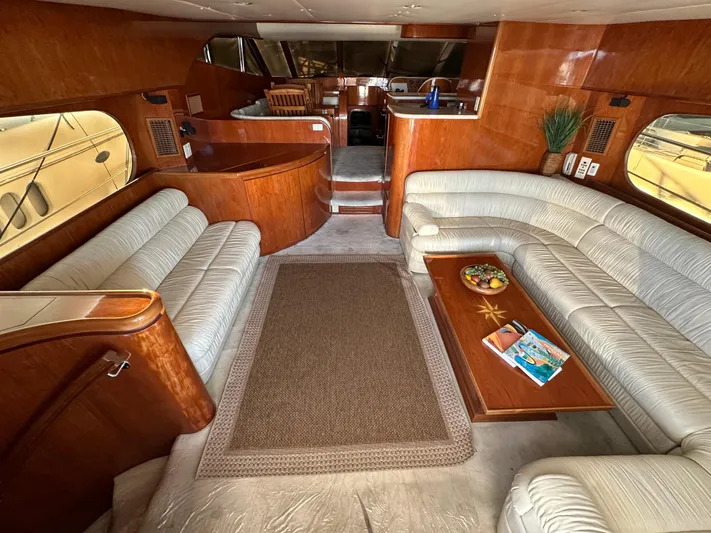 Euphoria Yacht Photos Pics Luxurious 2001 Johnson 70 yacht interior with plush seating and elegant wood finishes.