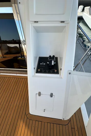 Euphoria Yacht Photos Pics Control panel on a 2001 Johnson 70 yacht, featuring sleek design and wooden deck.