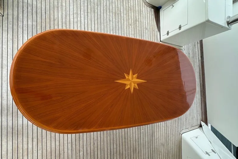 Euphoria Yacht Photos Pics Elegant wooden table with star inlay on a Johnson 70 yacht, 2001 model.