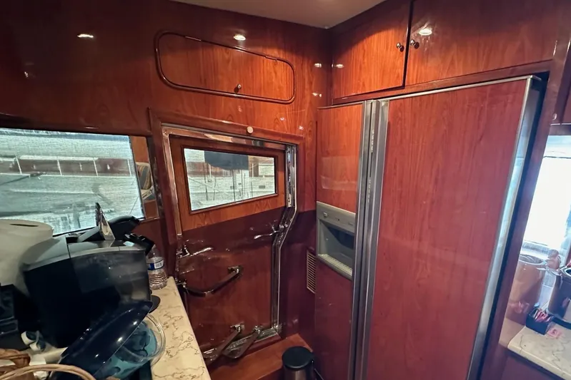 Euphoria Yacht Photos Pics Luxurious 2001 Johnson 70 yacht interior with wood paneling and modern kitchen amenities.