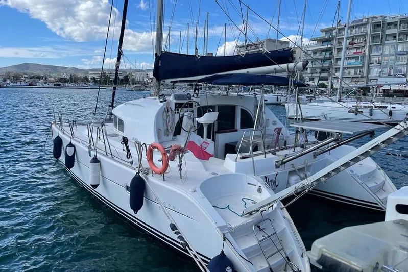 Lagoon 380 Yacht Photos Pics 2002 Lagoon 380 catamaran docked at a marina, surrounded by other boats.