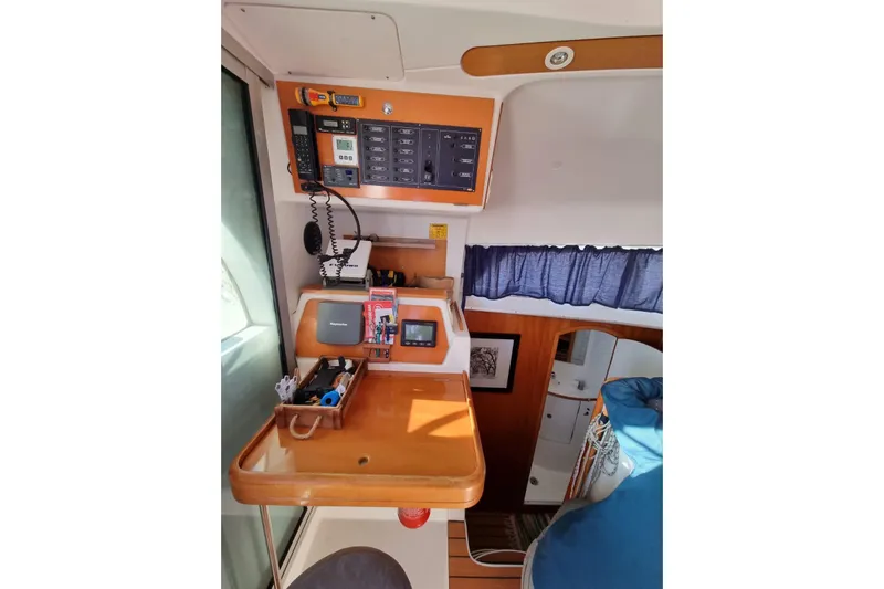 Lagoon 380 Yacht Photos Pics Interior of 2002 Lagoon 380 catamaran with navigation equipment and cozy cabin space.
