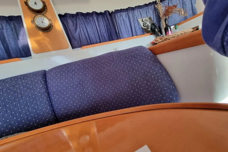 Lagoon 380 Yacht Photos Pics Interior of a 2002 Lagoon 380 catamaran with blue upholstery and nautical decor.