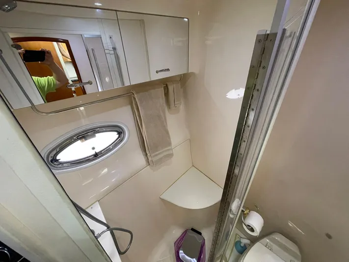 Rudee's Ruckus Yacht Photos Pics Bathroom interior of 2006 Carver 466 Motor Yacht with shower and porthole window.