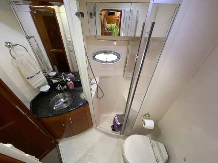 Rudee's Ruckus Yacht Photos Pics Bathroom interior of 2006 Carver 466 Motor Yacht with shower, sink, and toilet.