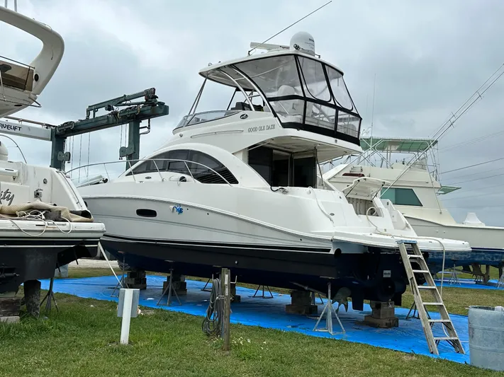  Yacht Photos Pics 2008 Sea Ray 47 Sedan Bridge yacht on dry dock, surrounded by other boats.