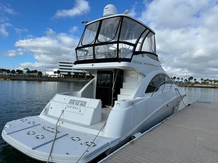  Yacht Photos Pics 2008 Sea Ray 47 Sedan Bridge yacht docked, featuring sleek design and spacious upper deck.