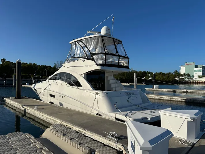  Yacht Photos Pics 2008 Sea Ray 47 Sedan Bridge yacht docked at marina under clear blue sky.