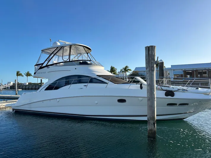  Yacht Photos Pics 2008 Sea Ray 47 Sedan Bridge yacht docked in a marina under clear blue sky.