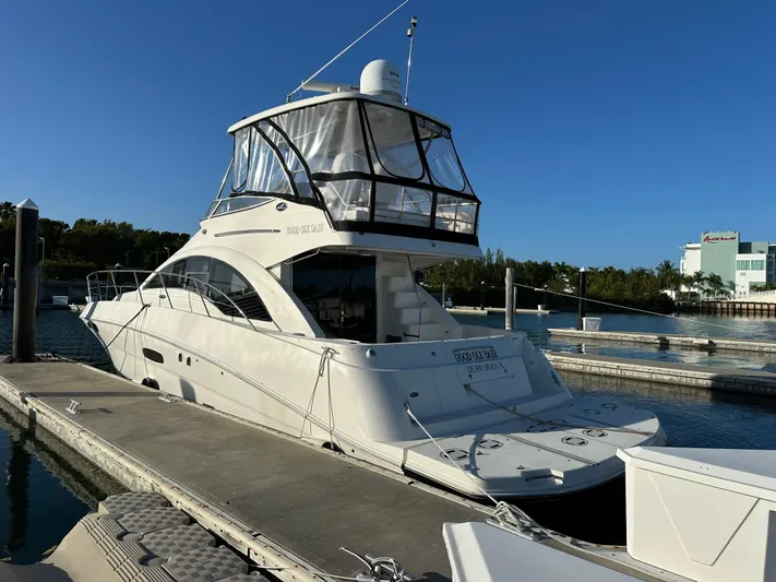  Yacht Photos Pics 2008 Sea Ray 47 Sedan Bridge yacht docked at marina under clear blue sky.
