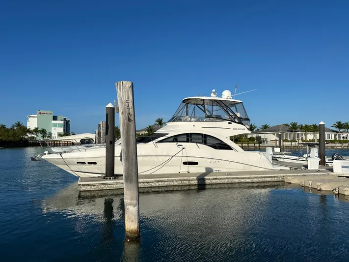  Yacht Photos Pics 2008 Sea Ray 47 Sedan Bridge yacht docked at marina under clear blue sky.