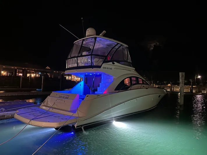  Yacht Photos Pics 2008 Sea Ray 47 Sedan Bridge yacht illuminated at night in a marina.