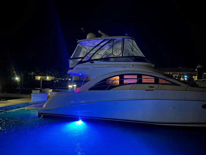  Yacht Photos Pics 2008 Sea Ray 47 Sedan Bridge yacht illuminated at night with blue underwater lights.