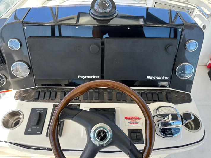  Yacht Photos Pics 2008 Sea Ray 47 Sedan Bridge helm with Raymarine displays and wooden steering wheel.