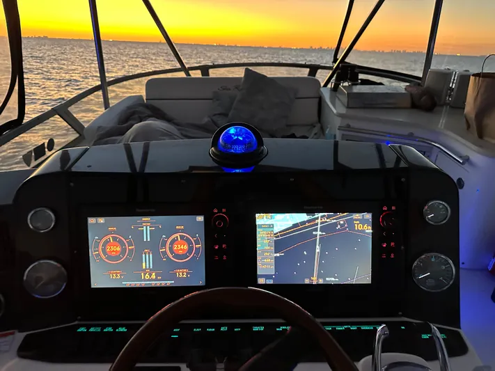  Yacht Photos Pics 2008 Sea Ray 47 Sedan Bridge helm with sunset view, featuring advanced navigation displays.