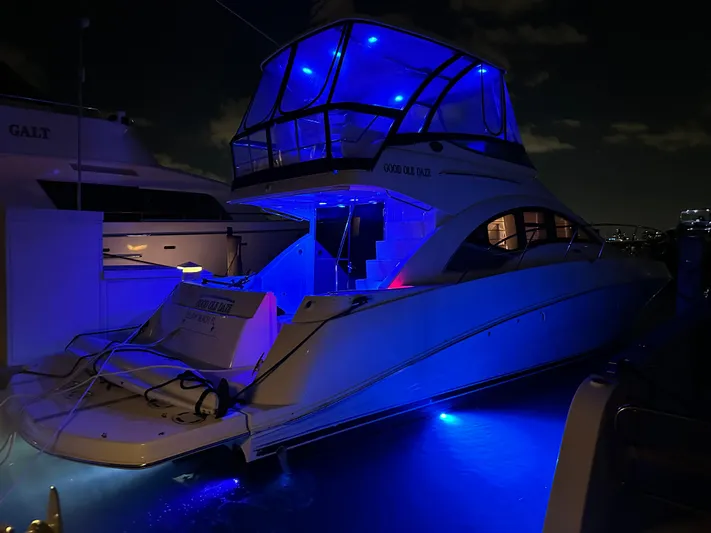 Yacht Photos Pics 2008 Sea Ray 47 Sedan Bridge yacht illuminated with blue lights at night.