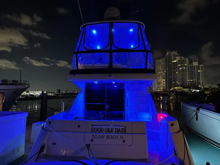  Yacht Photos Pics 2008 Sea Ray 47 Sedan Bridge yacht illuminated with blue lights at night, docked in Delray Beach.