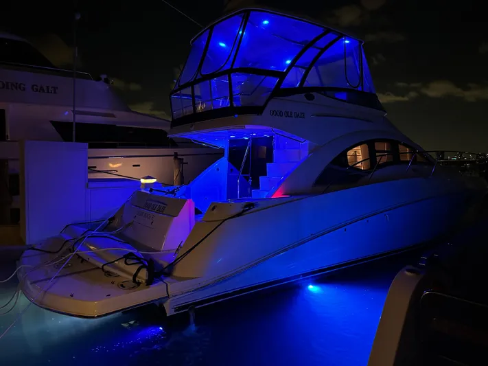  Yacht Photos Pics 2008 Sea Ray 47 Sedan Bridge yacht illuminated with blue lights at night.