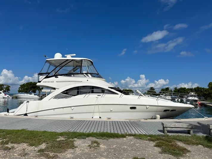  Yacht Photos Pics 2008 Sea Ray 47 Sedan Bridge yacht docked under clear blue sky.