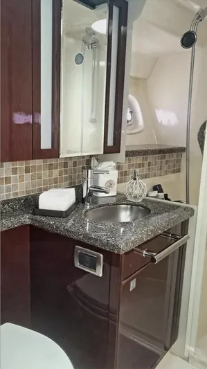  Yacht Photos Pics Luxurious bathroom in 2008 Sea Ray 47 Sedan Bridge yacht with modern fixtures and granite countertop.