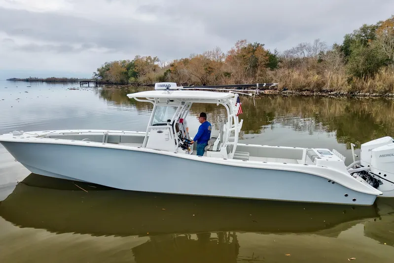  Yacht Photos Pics 2023 Cape Horn 34 XS boat on calm water, surrounded by autumn trees.