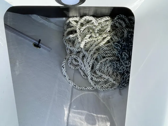 Med Blue Yacht Photos Pics Anchor storage compartment on 2025 Blackfin 272CC boat with coiled rope and chain.