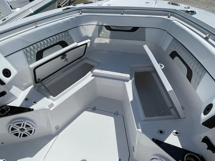 Med Blue Yacht Photos Pics 2025 Blackfin 272CC boat interior with open storage compartments and sleek white seating.