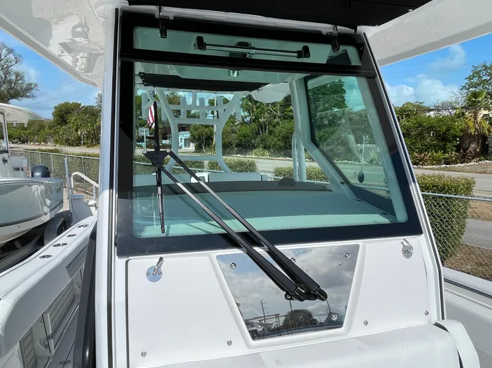 Med Blue Yacht Photos Pics 2025 Blackfin 272CC boat windshield with wipers, docked outdoors.