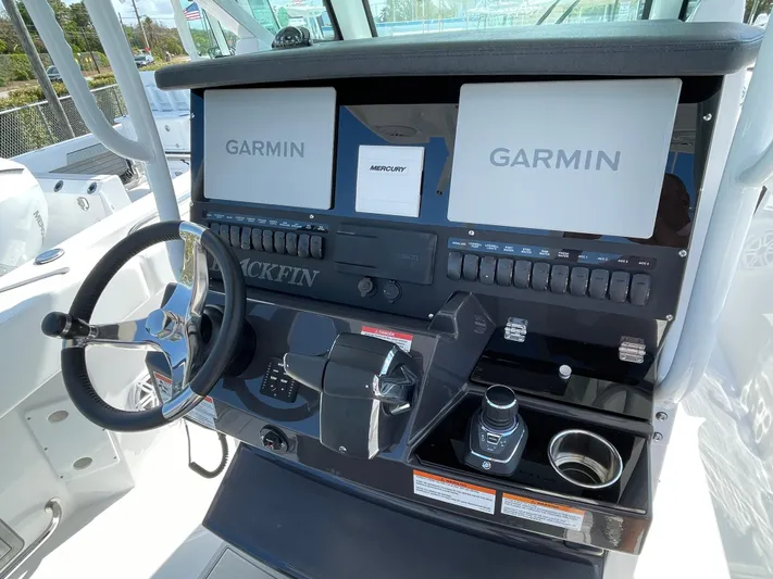 Med Blue Yacht Photos Pics 2025 Blackfin 272CC boat dashboard with Garmin displays and steering wheel.