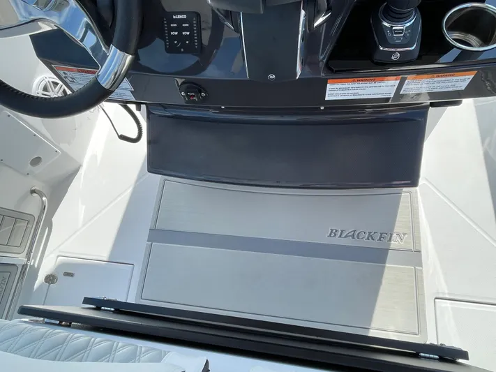 Med Blue Yacht Photos Pics 2025 Blackfin 272CC boat cockpit with steering wheel and control panel.