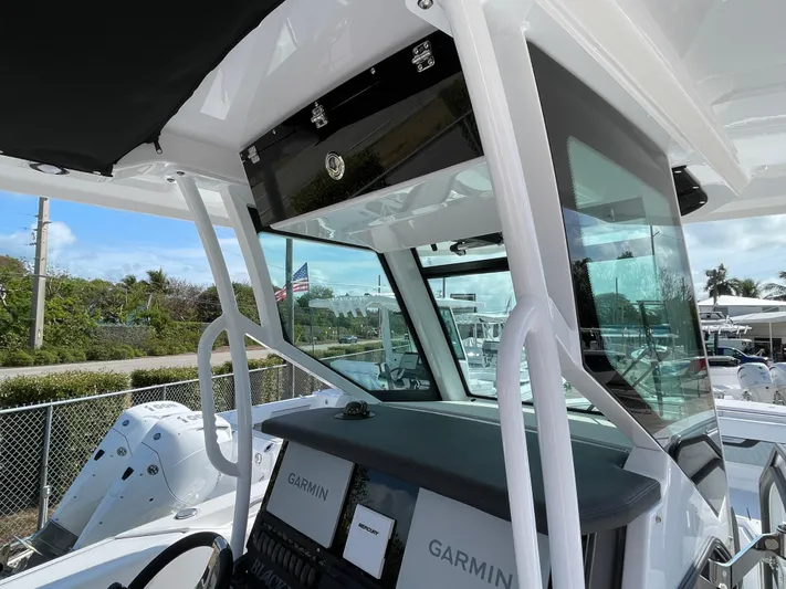 Med Blue Yacht Photos Pics 2025 Blackfin 272CC boat cockpit with Garmin navigation system and modern design.