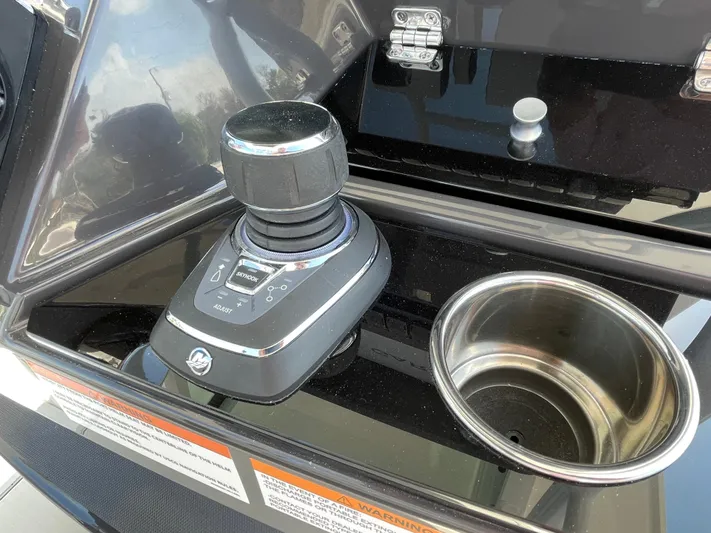 Med Blue Yacht Photos Pics Control panel of 2025 Blackfin 272CC boat with joystick and cup holder.