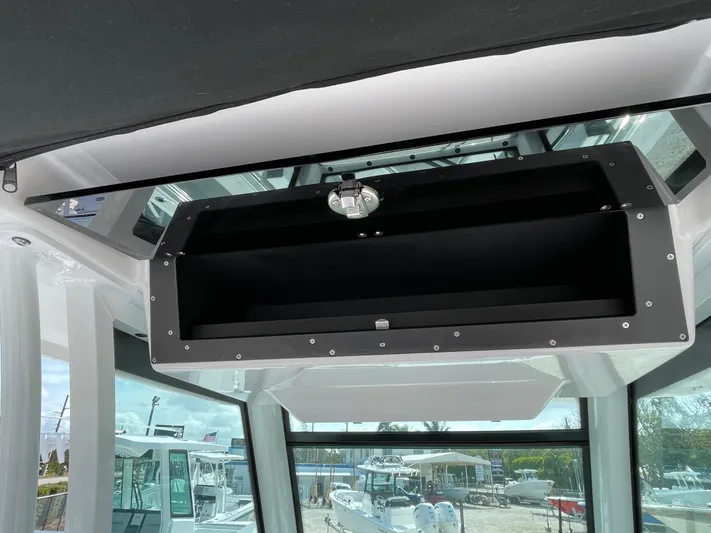 Med Blue Yacht Photos Pics 2025 Blackfin 272CC boat interior with overhead storage compartment.