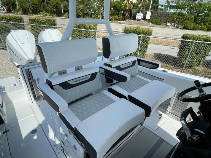 Med Blue Yacht Photos Pics 2025 Blackfin 272CC boat interior with white cushioned seating and modern design.