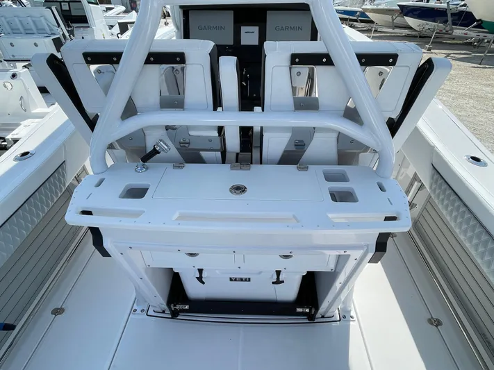 Med Blue Yacht Photos Pics 2025 Blackfin 272CC boat console with Garmin displays and seating.