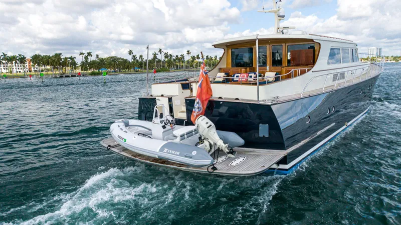 Essence Yacht Photos Pics 2006 Vicem 85 Classic yacht cruising on open water with inflatable boat attached.