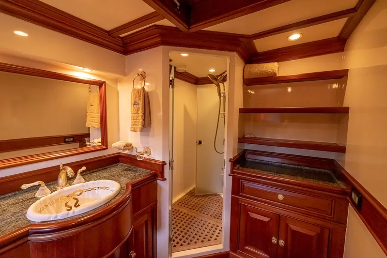 Essence Yacht Photos Pics Luxurious bathroom in 2006 Vicem 85 Classic yacht with elegant wood cabinetry and modern fixtures.