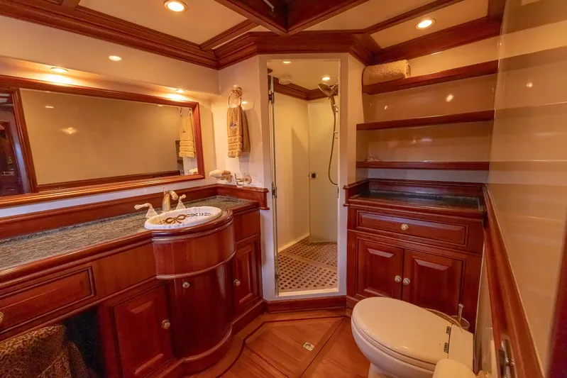 Essence Yacht Photos Pics Luxurious bathroom in 2006 Vicem 85 Classic yacht with wooden cabinetry and modern fixtures.
